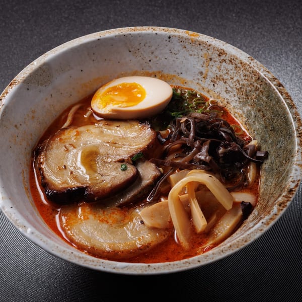 Kogane Ramen's spicy ramen bowl with pork, egg, bamboo shoots, and wood ear mushrooms.
